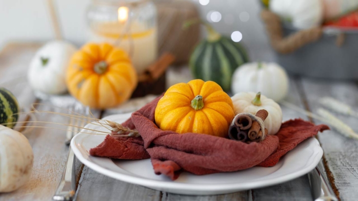 Photo of pumpkins and candle on a wooden table Photo of pumpkins and candle on a wooden table