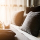 Photo of a bed maid-up with clean white pillows and bed sheets in beauty room