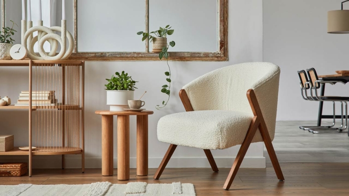 Stylish compositon of modern living room interior with frotte armchair, wooden commode, side table and elegant home accessories Stylish compositon of modern living room interior with frotte armchair, wooden commode, side table and elegant home accessories