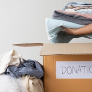 woman hands holding clothes putting in a donation box