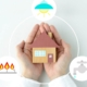 Human's hands and house object with gas, electricity and water icons